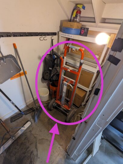 Circle and arrow around and pointing to the hand truck.