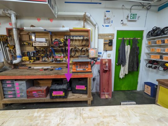 An arrow pointing to the location of the dual hand bandsaw.