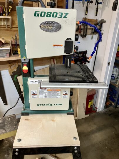A bandsaw mounted on a rolling cart