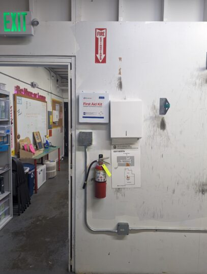 Fire extinguisher on metal shop wall